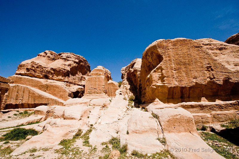 20100412_112343 D3.jpg - The freestanding cube shaped monument is known as  a 'djinn' block. Djinn is also the name for a type of spirit that is featured in Arab folklore. The name was adopted for these blocks as Petra's Bedoin occupants believed these monuments were the dwellings of djinn which were thought to inhabit the area. Today it is agreed that these monuments served as tombs and memorials to the dead. There are 25 of these blocks in Petra